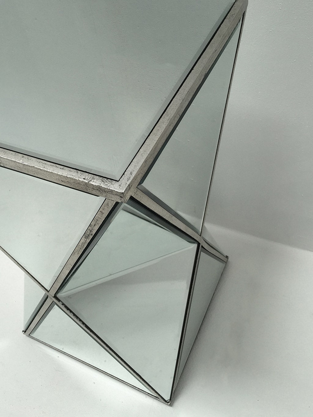 Charleston mirrored end table in geometric shape, all panels bevelled, wood and mirror, antiqued silver