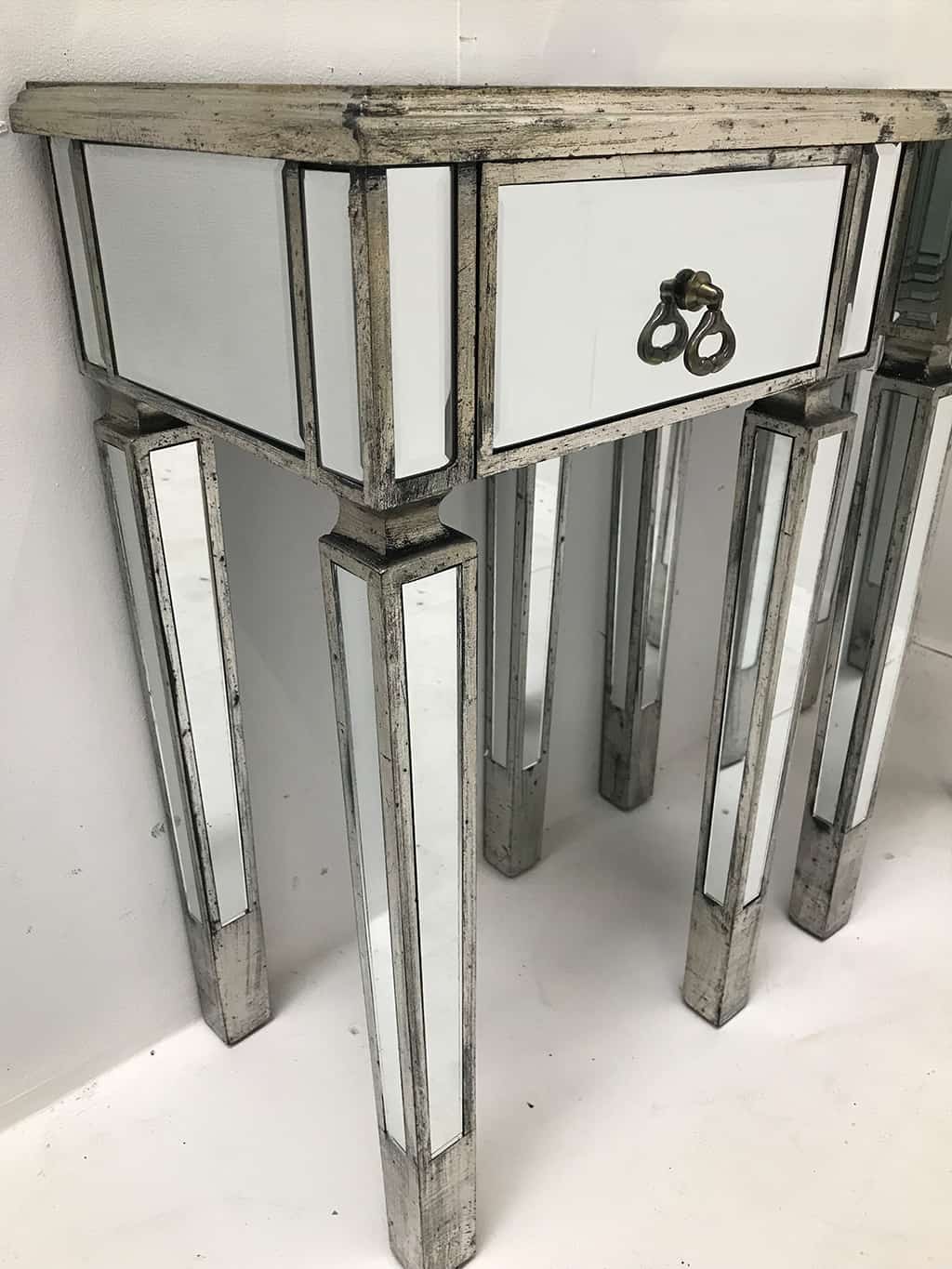 Pair of Mirrored Side Tables with wooden edging and antiqued slim silver finish from our stunning luxury Charleston collection. Brass drop handles, one drawer, wood and mirror, antique silver finish