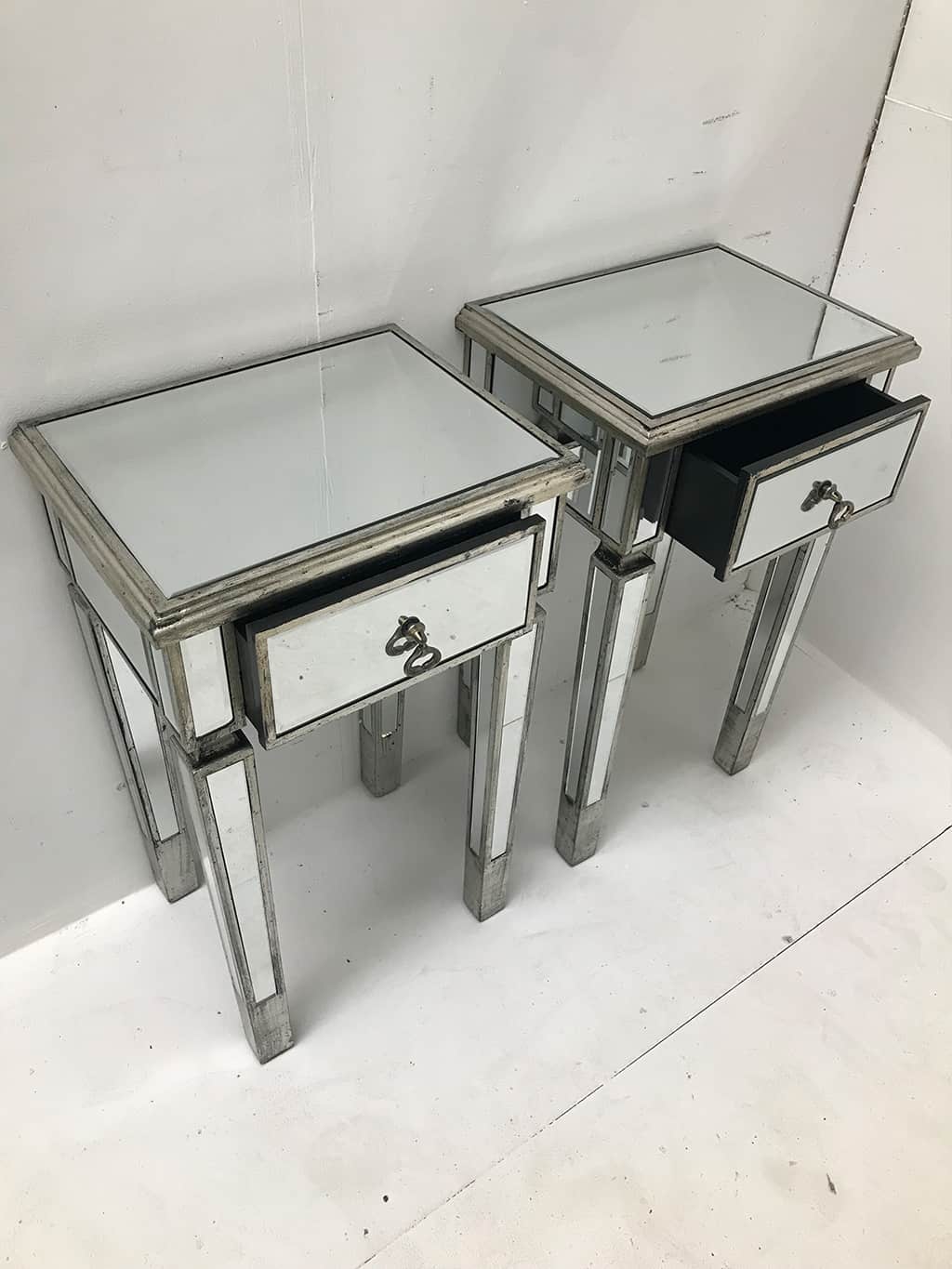 Couple of Mirrored Bedside Tables with wooden edging and antiqued slim silver finish from our stunning luxury Charleston collection. Brass drop handles, one drawer, wood and mirror, antique silver finish