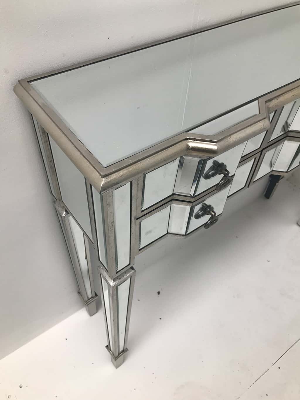 Charleston mirrored console table, six drawers, wood and mirror, antiqued silver, brass drop handles
