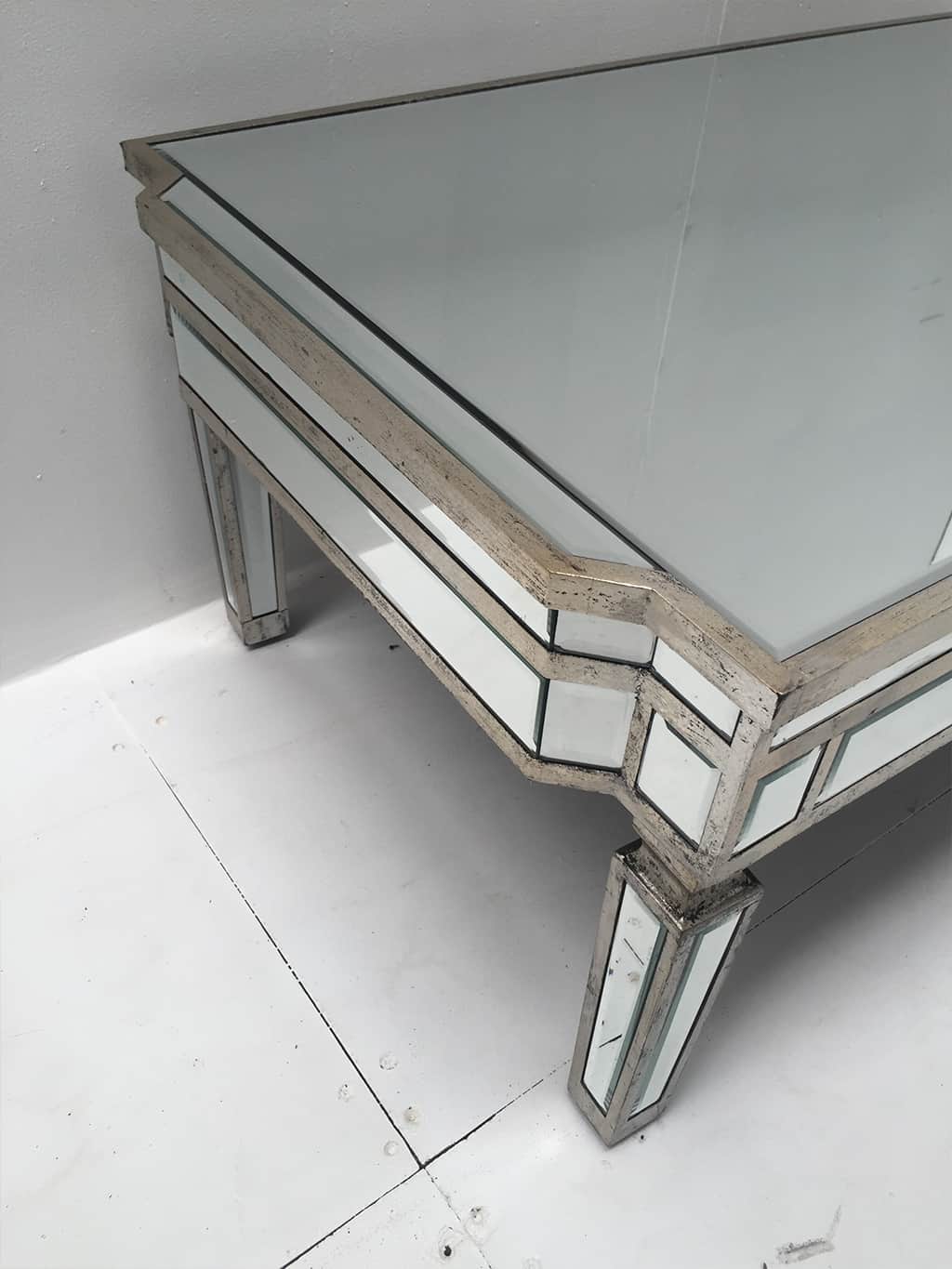 Rectangle mirrored coffee table with an antiqued silver wooden edging with a bevelled mirror top