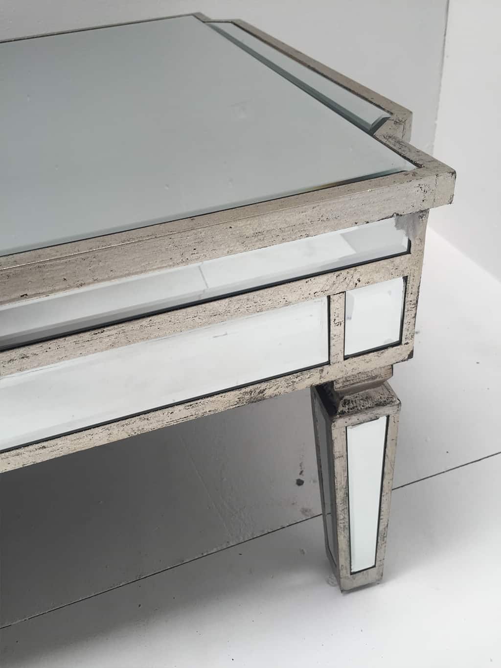 Charleston mirrored coffee table with an antiqued silver wooden edging with a bevelled mirror top
