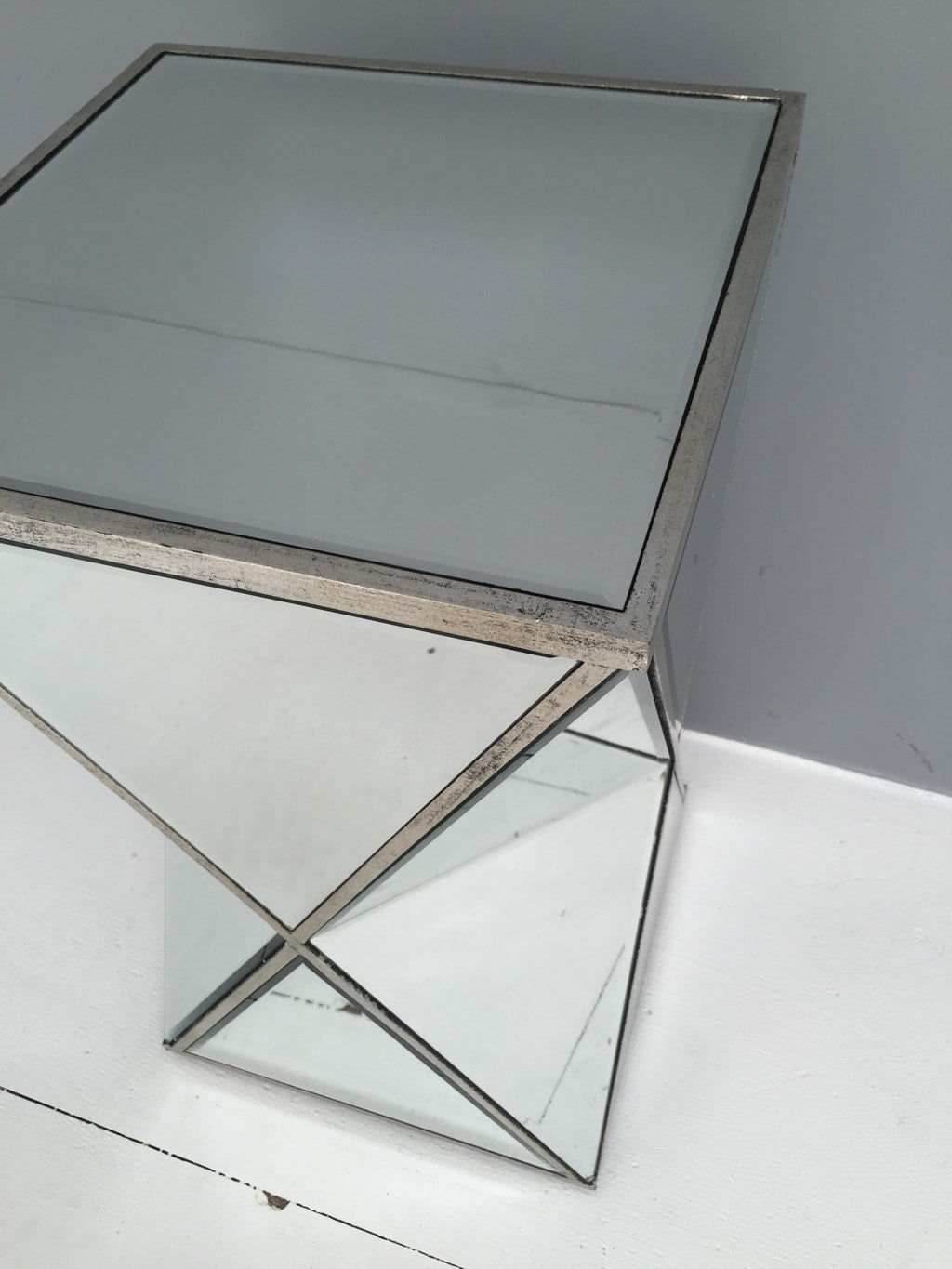 Mirrored side table in geometric shape,  all panels bevelled, wood and mirror, antiqued silver