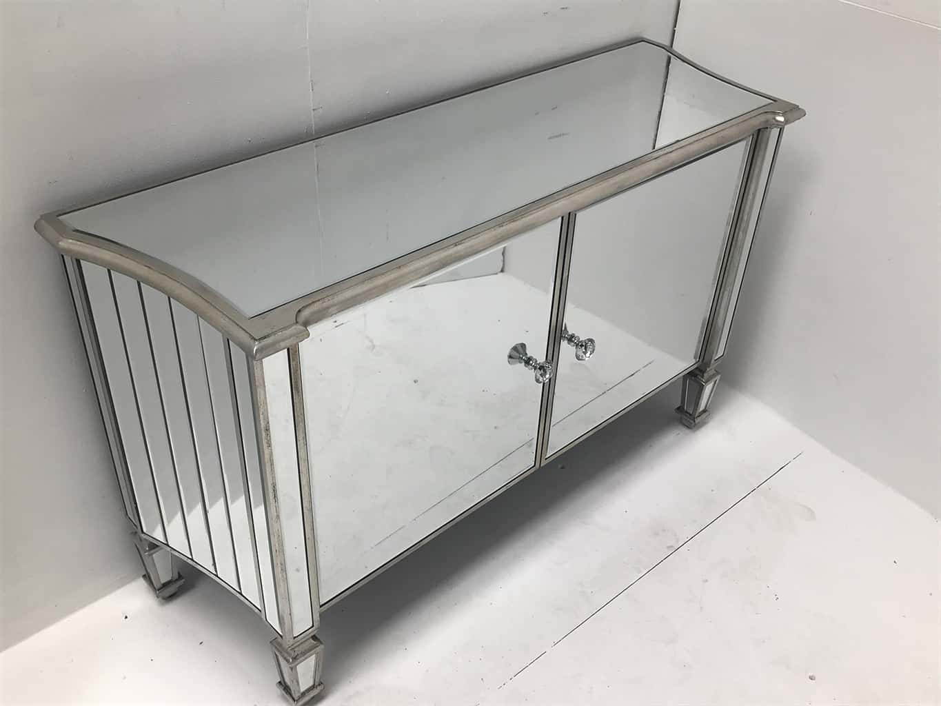 mirrored sideboard with 2 cupboard doors. All mirrored panels are bevelled and the ends are curved, crystal knobs, wood and mirror, antiqued silver.